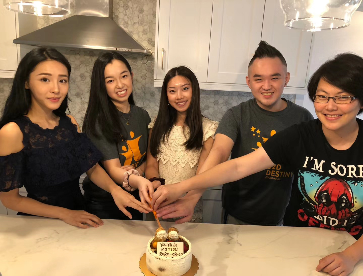 Young Ambassador members cut a cake to celebrate youth in motion