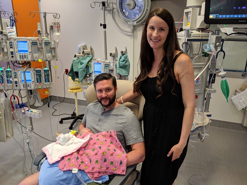 Quinn's parents hold her in the PICU
