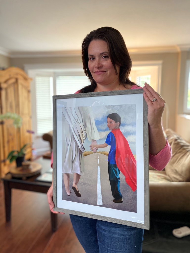 Cameron's mom holds a portrait of him walking with a cape on