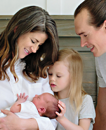 Jenny with her husband and two young children